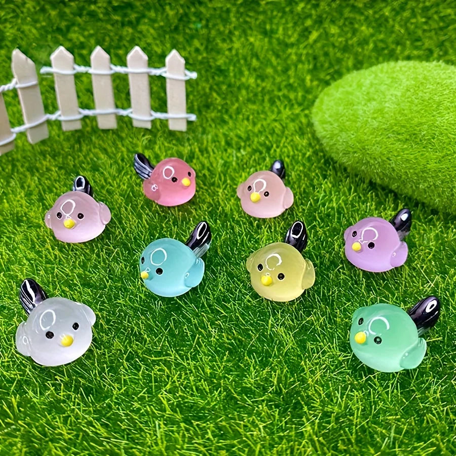A set of mini luminous resin bird fairy garden decor featuring various colored birds on green moss.
