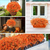 An orange artificial fall floral decor set featuring bright orange and yellow flowers displayed in various pots and window bo