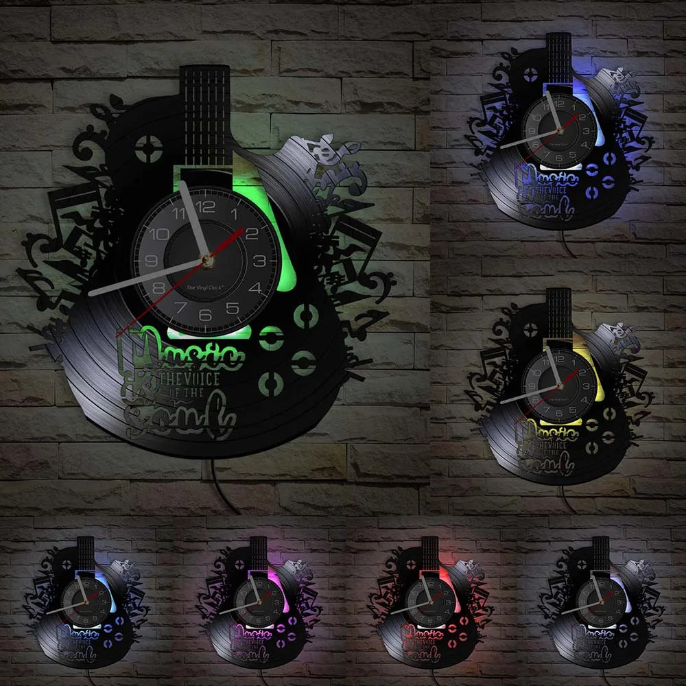 A collection of vintage vinyl record guitar wall clocks displayed against a brick background.