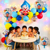 A colorful arch garland made of balloons featuring cartoon clown designs and various bright colors for a party.