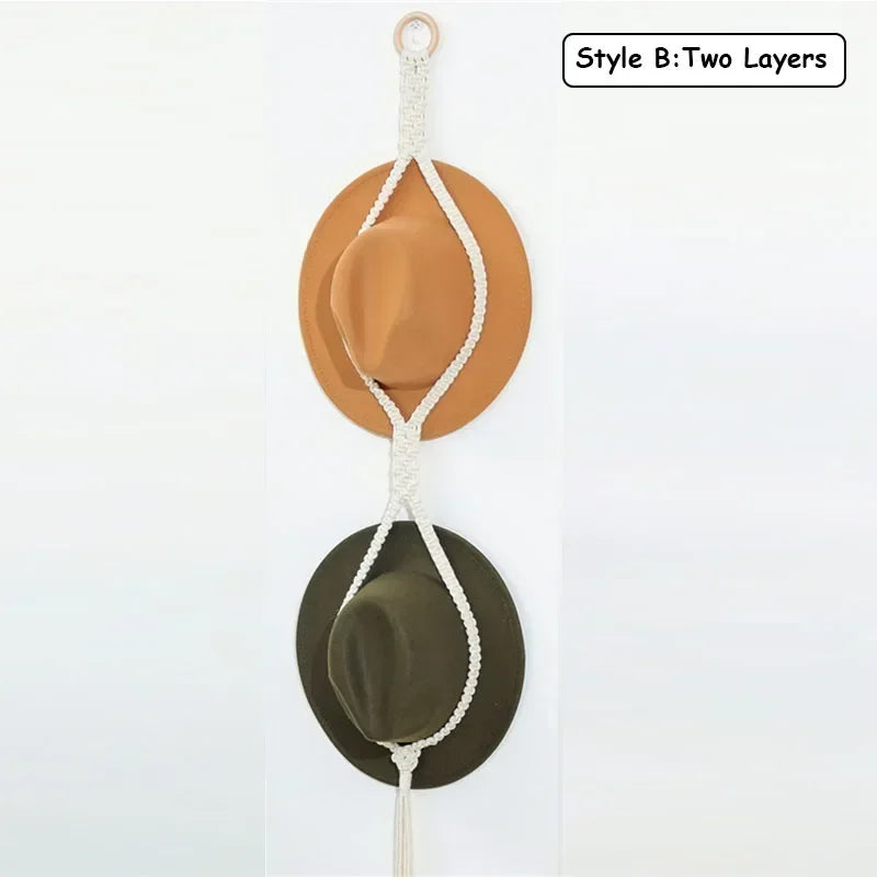 Two layers of macrame hat organizers featuring a light brown and olive green felt hat hanging from a wooden dowel