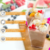 A glass dessert cup filled with a brown mousse or pudding, topped with whipped cream and fruit, next to various fresh fruits.