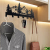 A black metal key holder with hooks mounted on a wall above a striped shirt.