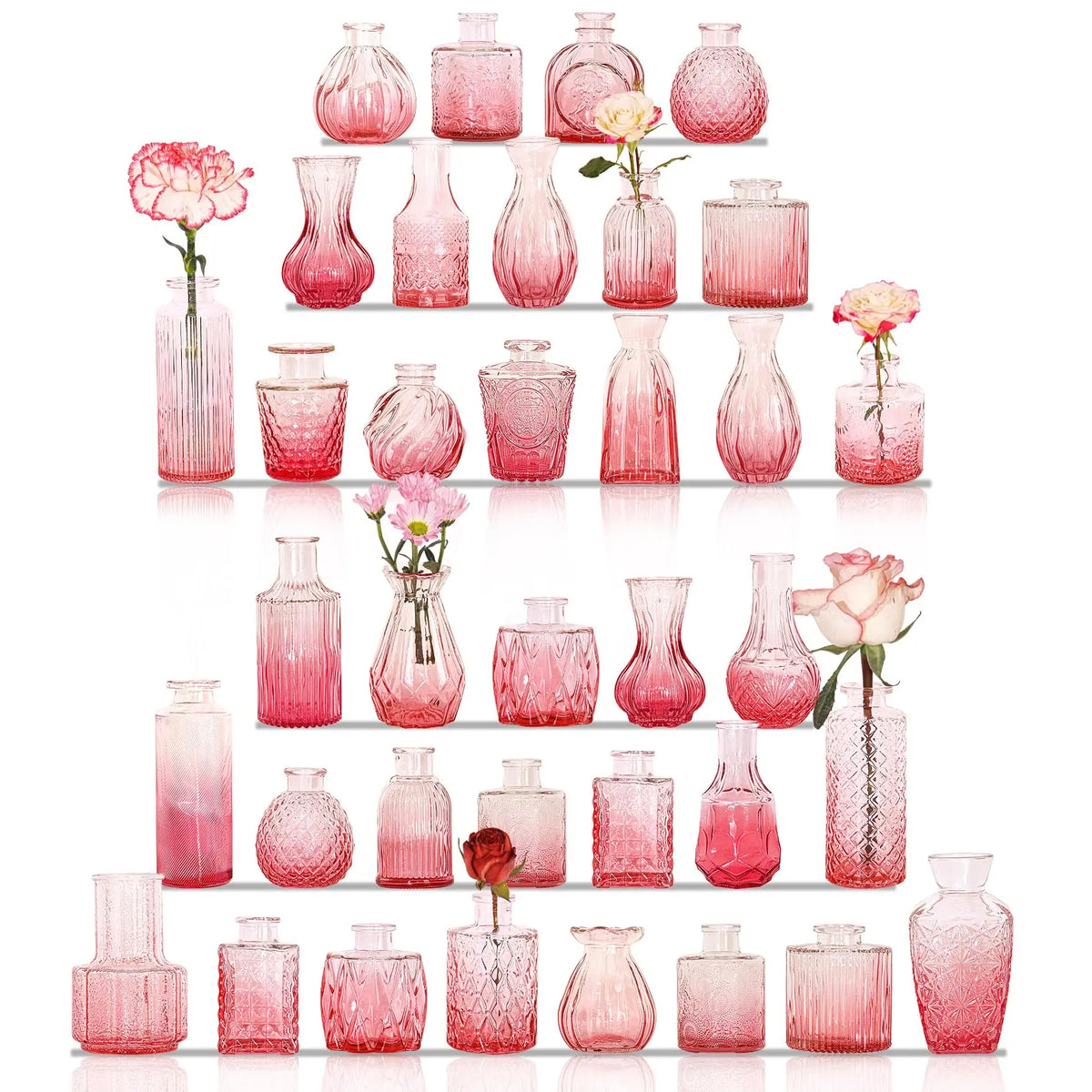 A collection of vintage pink and rose-colored glass vases and bottles arranged in a vertical display.
