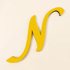 A yellow 3D acrylic letter N wall sticker against a light background.