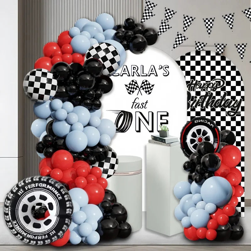 A balloon arch set featuring red, black, and blue balloons with a checkered pattern and racing theme graphics.
