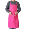 A person wearing a bright pink waterproof kitchen apron with a front pocket over a gray sweater.