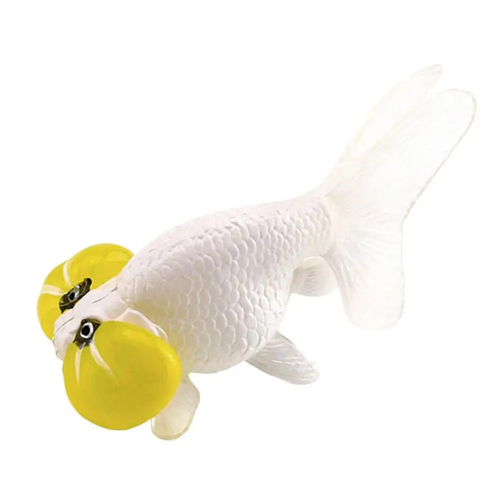 A realistic figurine of a goldfish with yellow accents and white body.