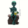 Resin green alien statue holding a glass of beer