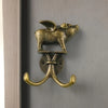 A decorative metal wall hook shaped like a fox head mounted on a curved hook.