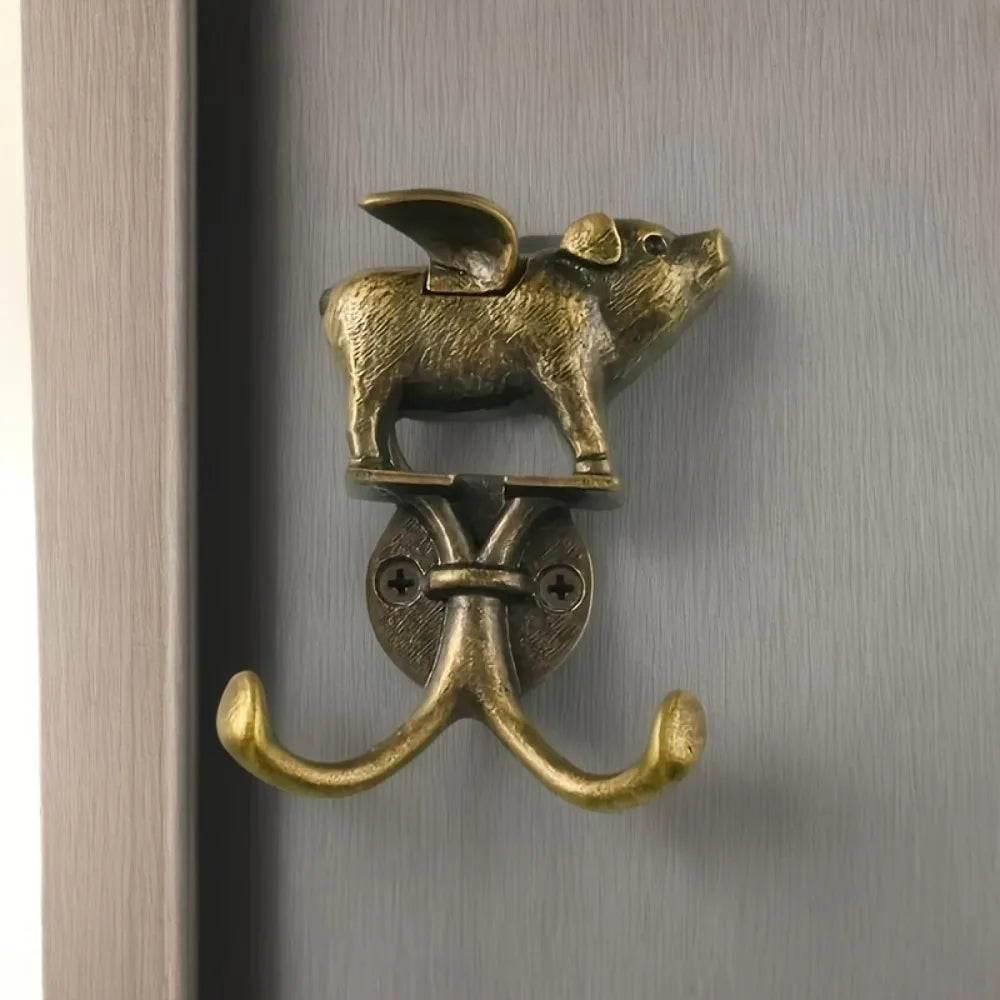 A decorative metal wall hook shaped like a fox head mounted on a curved hook.