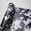 Roll of color-changing digital camouflage vinyl wrap film showing a gray and white pattern.