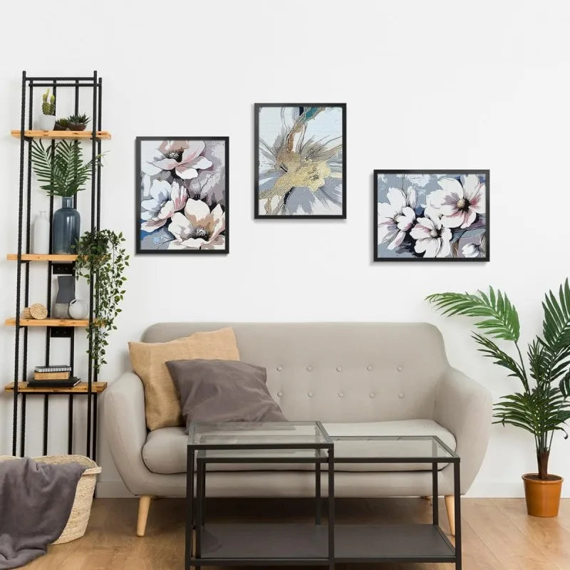 A modern living room display featuring framed artwork and a light gray sofa.