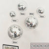 A collection of silver disco balls of various sizes, including 10cm, 12cm, 15cm, 20cm, and 25cm, displayed against a white ba
