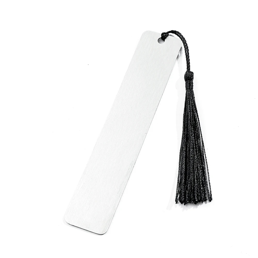 A white bookmark with a black dragon tassel hanging from it.