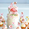 A tiered cake decorated with pink and white floral elements and butterfly toppers on a white background.