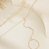 Gold ultra-thin layering chain bracelets with small clear stones displayed on a light background.