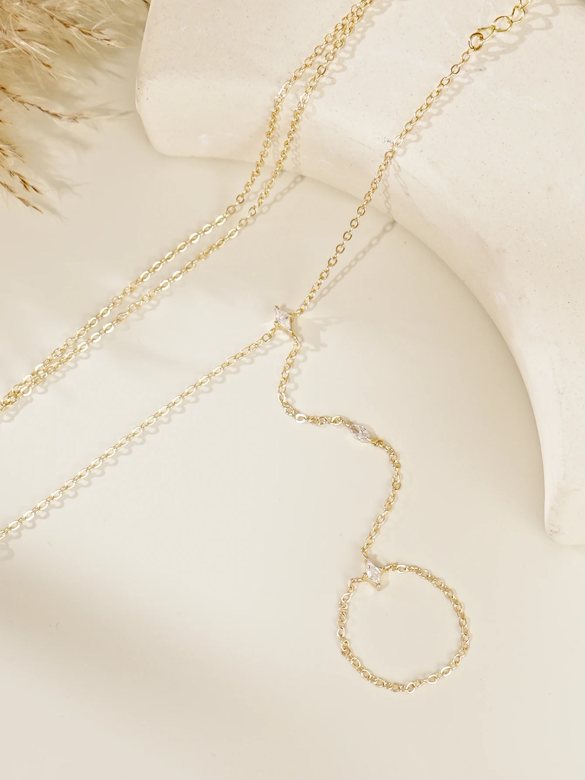 Gold ultra-thin layering chain bracelets with small clear stones displayed on a light background.