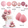 Pink ball decorations and fan shaped toppers for a birthday cake display