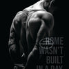 A muscular man's back is shown in a silhouette against a dark background, with text that reads Wasn't Built in a Day.