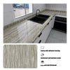 A marble pattern self-adhesive backsplash panel installed on a kitchen countertop with a sink.