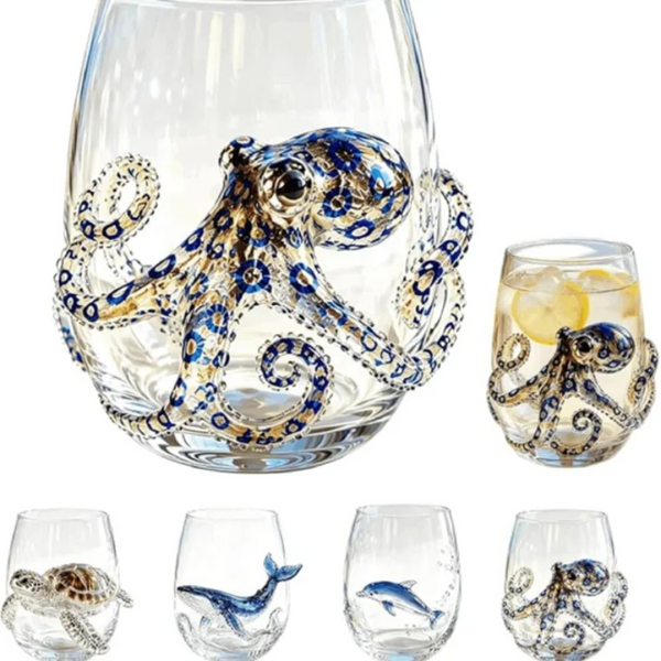 A clear wine glass filled with ice and garnished with a handcrafted blue-ringed octopus decoration.