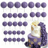 A set of purple foam cake toppers on sticks, including various sizes and shapes.