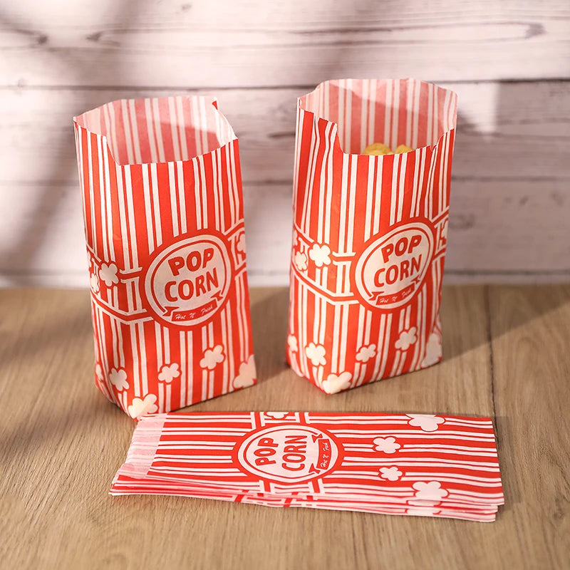 Two red and white striped paper popcorn buckets filled with popcorn