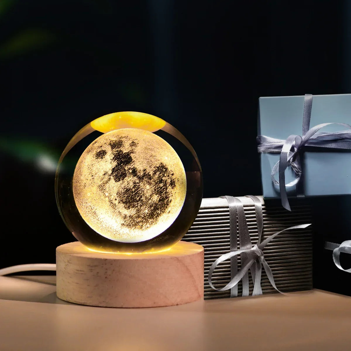 Galaxy crystal ball night light with a glowing moon inside on a wooden base