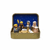 A classic PVC Christmas nativity scene figurine set displayed in a gold storage tin with a blue starry background.