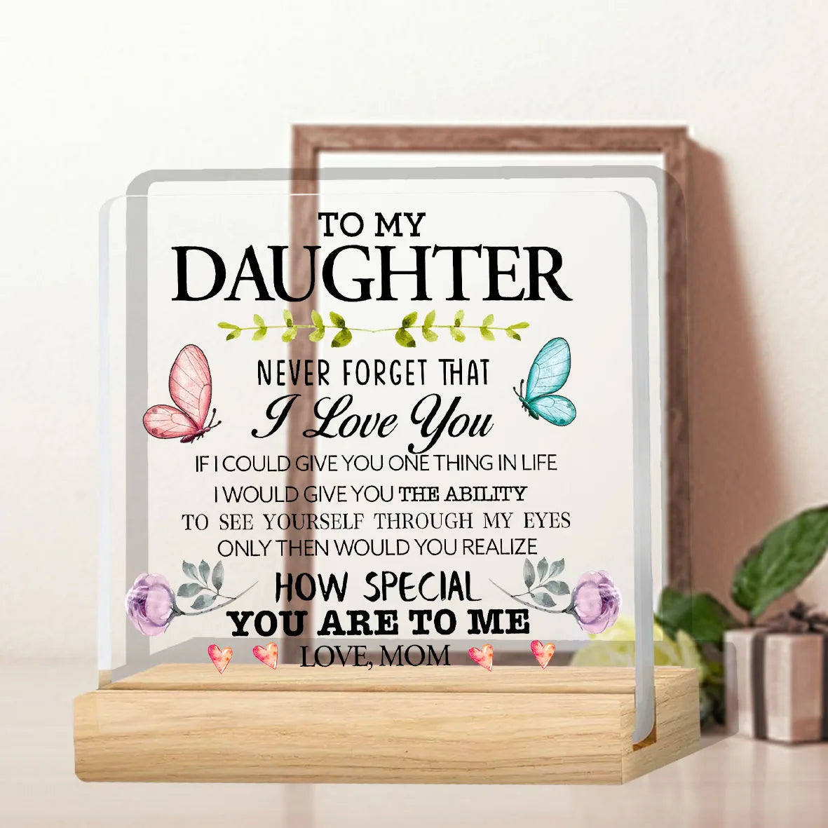 A personalized acrylic desk sign with a floral design and text saying I love you to my daughter
