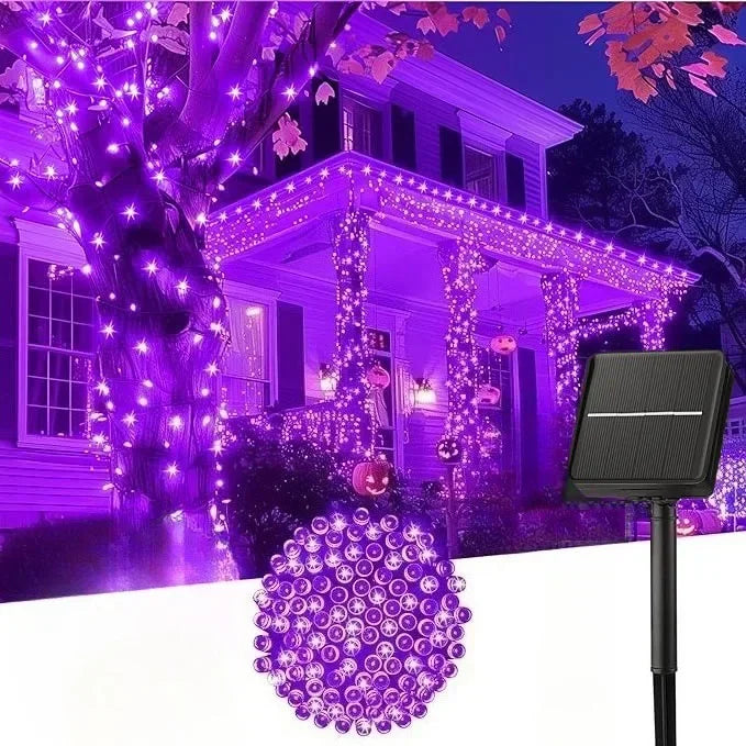 Purple LED string lights illuminating a house and tree for outdoor decoration