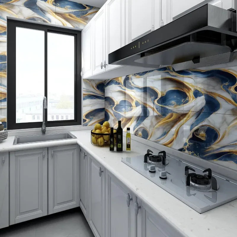 A kitchen featuring white cabinets, a marble backsplash with blue and gold veining, and a black range hood.
