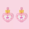 A pair of pink My Little Pony Magic Bottle collectible figurines with yellow bows.