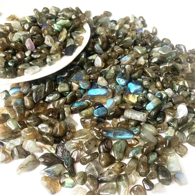 A pile of natural tumbled gemstone chips in various shades of green and blue.