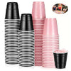 A set of black and pink striped mini plastic shot cups for parties and events.
