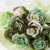 A bouquet of satin silk ribbon roses in shades of sage green, cream, and pale mint green.