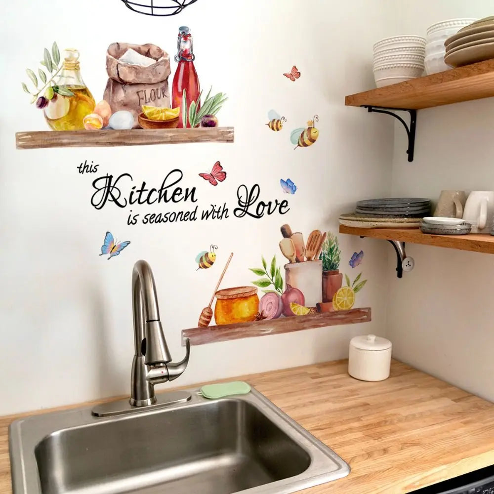 A kitchen wall decorated with bee and butterfly decals above a stainless steel sink.