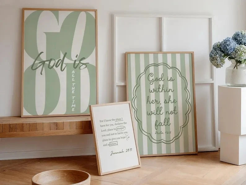 Art wall featuring scripture: God is always and God is within her. She will not fall on a light wood shelf.