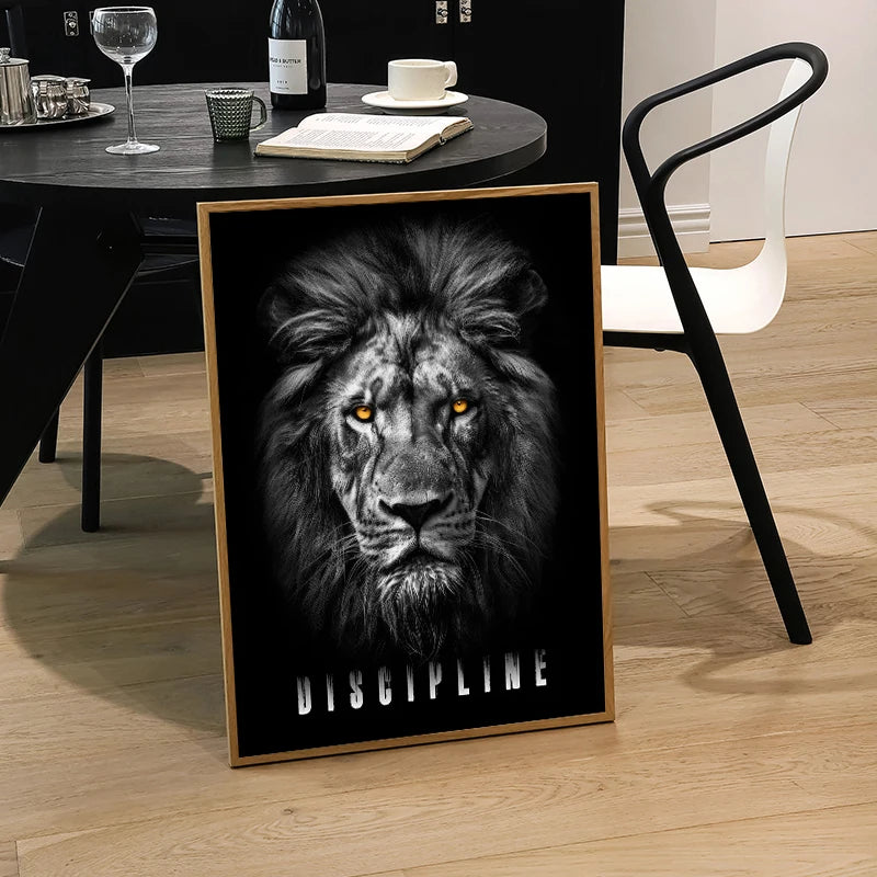 A framed canvas print featuring a close-up portrait of a fierce lion's face with intense yellow eyes against a black backgrou