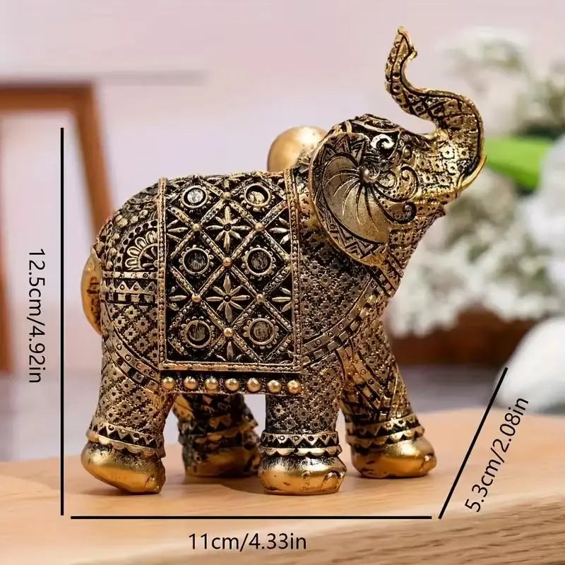 A vintage resin elephant ornament with gold detailing, displayed on a wooden surface.