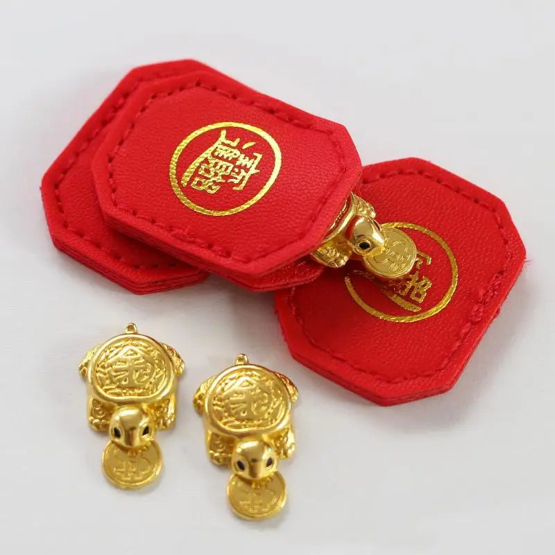 Red felt tags with gold foil characters and brass turtle charms for fengshui