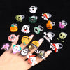 A collection of glow-in-the-dark Halloween rings featuring skulls, pumpkins, and spooky faces.