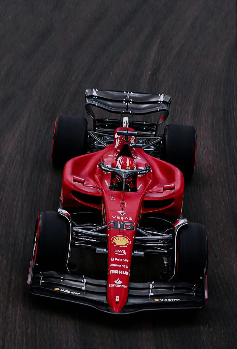 A red Formula 1 racing car model on a dark background.