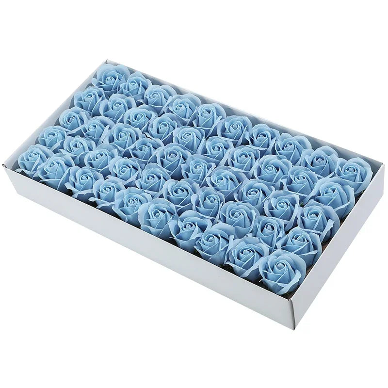 A box filled with light blue artificial rose heads for wedding and party decoration.