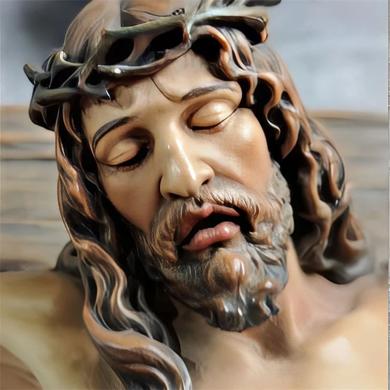 A realistic resin figurine of Jesus with a crown of thorns and long hair, depicting him in a sorrowful expression.