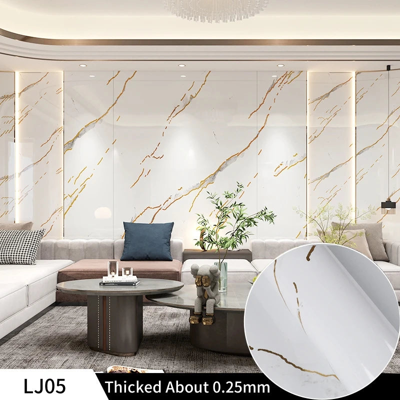 A close-up view of white marble contact paper showing natural veining and gold accents.