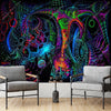 A vibrant tapestry featuring psychedelic UV patterns and glowing geometric shapes displayed on a wall.