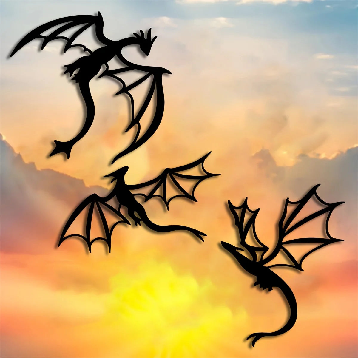 Three black dragon silhouettes in flight against a sunset sky.