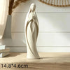 A white gold praying angel figurine statue standing on a wooden surface.